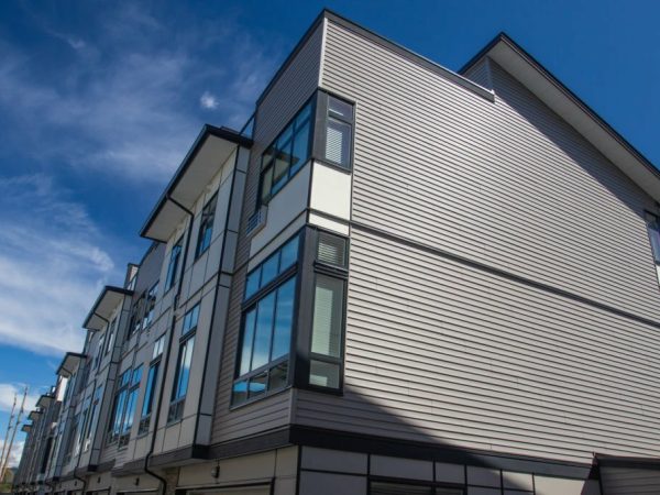 Nice development of new townhouses. Rows of townhomes side by side. External facade of a row of colorful modern urban townhouses. brand new houses just after construction on real estate market.