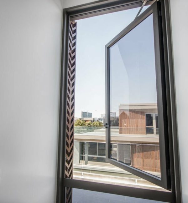 Large glass windows with aluminum frames in the room.