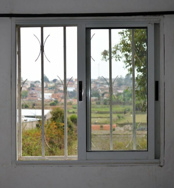 PVC window with protective grid seen from inside.